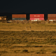 A Union Pacific freight train carries cargo shipping containers along a rail line at sunset in Bosler, Wyoming on August 13, 2022.